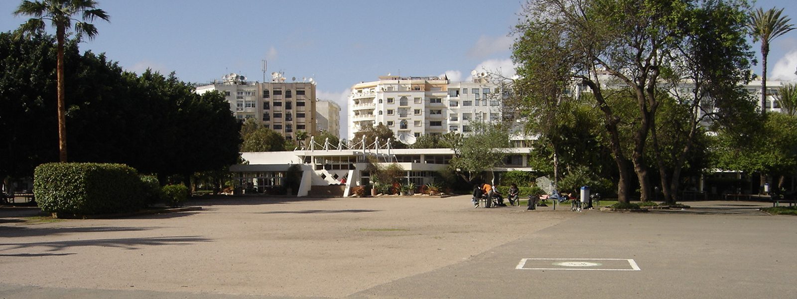 The main courtyard of Lycée Lyautey in Casablanca, lined with palm trees and low buildings