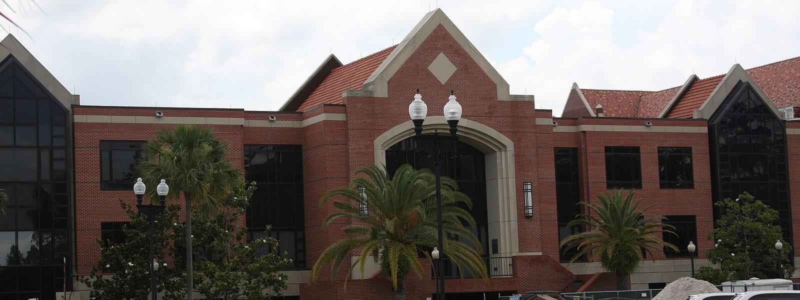 The red-brick front of Criser Hall among palm trees at the University of Florida